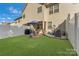 This backyard features a patio with a grill and an outdoor dining area with a lush lawn at 8031 Scarlet Oak Ter, Indian Land, SC 29707