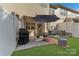 This backyard features a patio with a grill and an outdoor dining area with a lush lawn at 8031 Scarlet Oak Ter, Indian Land, SC 29707