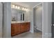 Bright bathroom boasts a dual sink vanity, tiled floors and a private toilet area at 8031 Scarlet Oak Ter, Indian Land, SC 29707