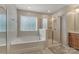 This bathroom features a large soaking tub, glass shower and a large window for natural light at 8031 Scarlet Oak Ter, Indian Land, SC 29707