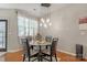 Dining area featuring a modern chandelier and glass table at 8031 Scarlet Oak Ter, Indian Land, SC 29707