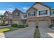 Desirable townhome featuring neat lawns, private garages, and a welcoming exterior design under a clear blue sky at 8031 Scarlet Oak Ter, Indian Land, SC 29707