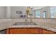 Close-up of kitchen sink with granite countertops and tile backsplash at 8031 Scarlet Oak Ter, Indian Land, SC 29707