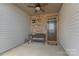 Inviting porch showcasing a brick wall, door with glass panes, bench seating, and a welcoming atmosphere at 8031 Scarlet Oak Ter, Indian Land, SC 29707