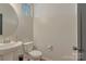 Small powder room with pedestal sink and modern fixtures at 8031 Scarlet Oak Ter, Indian Land, SC 29707