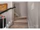 A stairway with carpet treads and white risers ascends to the upper level of the home at 8031 Scarlet Oak Ter, Indian Land, SC 29707