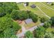Aerial view of the property featuring lush greenery, mature trees, and a long driveway at 804 Gw Broome Rd, Monroe, NC 28112