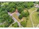 Aerial view of a home surrounded by lush green trees and a nearby road at 804 Gw Broome Rd, Monroe, NC 28112