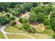 Aerial view of the property surrounded by trees with a partially fenced yard at 804 Gw Broome Rd, Monroe, NC 28112