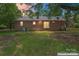 Rear exterior view highlighting the home's brick facade, sliding glass door, and ample backyard space at 804 Gw Broome Rd, Monroe, NC 28112