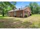 Brick home exterior featuring a rear patio, landscaped yard, and classic architectural details at 804 Gw Broome Rd, Monroe, NC 28112
