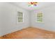 Cozy bedroom with natural light from two windows, featuring hardwood floors at 804 Gw Broome Rd, Monroe, NC 28112