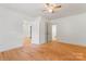 Bright bedroom featuring hardwood floors, a ceiling fan, and convenient closet space at 804 Gw Broome Rd, Monroe, NC 28112