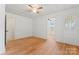 Bedroom featuring hardwood floors, a ceiling fan, and a decorative stained glass door at 804 Gw Broome Rd, Monroe, NC 28112