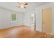 Bright bedroom with hardwood floors, a ceiling fan, and natural light from a large window at 804 Gw Broome Rd, Monroe, NC 28112