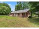 Classic single-story brick home with black shutters and a covered porch at 804 Gw Broome Rd, Monroe, NC 28112