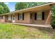 Traditional brick home featuring a covered front porch and well-maintained landscaping at 804 Gw Broome Rd, Monroe, NC 28112