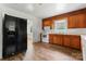 Functional kitchen with wood cabinets, white appliances, and vinyl floors at 804 Gw Broome Rd, Monroe, NC 28112