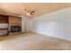 Spacious living room with a brick fireplace and ceiling fan at 804 Gw Broome Rd, Monroe, NC 28112