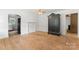 Spacious living room featuring original hardwood floors, an antique armoire and decorative fireplace at 804 Gw Broome Rd, Monroe, NC 28112