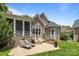 Backyard featuring brick patio, outdoor seating, and manicured lawn, perfect for relaxing and entertaining at 8701 Highgrove St, Charlotte, NC 28277
