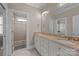 Bathroom featuring double sinks with marble countertops and a tiled shower with glass door at 8701 Highgrove St, Charlotte, NC 28277