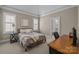 Comfortable bedroom featuring neutral walls, a desk, and an ensuite bathroom entrance at 8701 Highgrove St, Charlotte, NC 28277