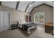 Cozy bedroom featuring a vaulted ceiling, ceiling fan, and a large window with shutters at 8701 Highgrove St, Charlotte, NC 28277