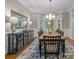 Elegant dining room with a large mirror, decorative chandelier, and access to natural light at 8701 Highgrove St, Charlotte, NC 28277