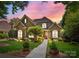 Charming brick home with lush landscaping and a beautiful walkway leading to the front door at 8701 Highgrove St, Charlotte, NC 28277