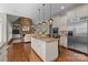 Open-concept kitchen with a center island, stainless appliances, and seamless flow to the living room at 8701 Highgrove St, Charlotte, NC 28277
