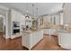 Bright, open kitchen with an island, stainless steel appliances, and granite countertops at 8701 Highgrove St, Charlotte, NC 28277