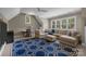 Comfortable living room with a large sectional sofa, accent rug, and bright windows at 8701 Highgrove St, Charlotte, NC 28277