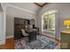 Cozy home office with built-in storage, arched window, and hardwood flooring at 8701 Highgrove St, Charlotte, NC 28277