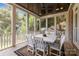 Relaxing screened porch featuring a ceiling fan and dining area with views of the outdoors at 8701 Highgrove St, Charlotte, NC 28277