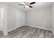 Bedroom features gray wood-look floors, neutral walls, and a closet at 894 Oval St, Kannapolis, NC 28081