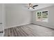 Cozy bedroom with gray vinyl plank flooring, a window, and neutral-toned walls at 894 Oval St, Kannapolis, NC 28081