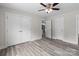Bedroom features gray wood-look floors, neutral walls, and multiple closets at 894 Oval St, Kannapolis, NC 28081