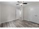 Bedroom features gray wood-look floors, neutral walls, and closet at 894 Oval St, Kannapolis, NC 28081