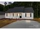 Charming single-story home with white siding, black shutters, and a well-maintained front yard at 894 Oval St, Kannapolis, NC 28081