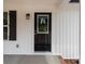 A close-up of the home's front door, featuring a window pane and a black finish at 894 Oval St, Kannapolis, NC 28081