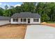 Charming single-story home featuring white siding, black shutters, a concrete driveway, and landscaped front yard at 894 Oval St, Kannapolis, NC 28081