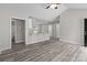 Spacious living room with gray vinyl plank flooring, vaulted ceilings, and an open floor plan at 894 Oval St, Kannapolis, NC 28081