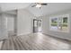 Sunlit living room showcasing vaulted ceilings, gray vinyl plank flooring, and an open entryway to the home's exterior at 894 Oval St, Kannapolis, NC 28081