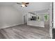 Bright and airy living room with vaulted ceilings, gray vinyl plank flooring, and an open view of the kitchen at 894 Oval St, Kannapolis, NC 28081