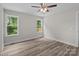 Bedroom with neutral walls, wood-look flooring, and two windows providing natural light at 896 Oval St, Kannapolis, NC 28081