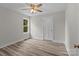 Bright bedroom featuring a ceiling fan, light gray walls, and wood-look vinyl floors at 896 Oval St, Kannapolis, NC 28081