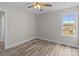 Bedroom featuring a window and light gray walls complemented by wood-look vinyl floors at 896 Oval St, Kannapolis, NC 28081