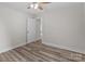 Bedroom with neutral walls and wood-look floors, showcasing a door leading to another room at 896 Oval St, Kannapolis, NC 28081