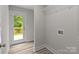 Laundry room showcasing door to deck, washer hookups, storage and wood-look vinyl flooring at 896 Oval St, Kannapolis, NC 28081